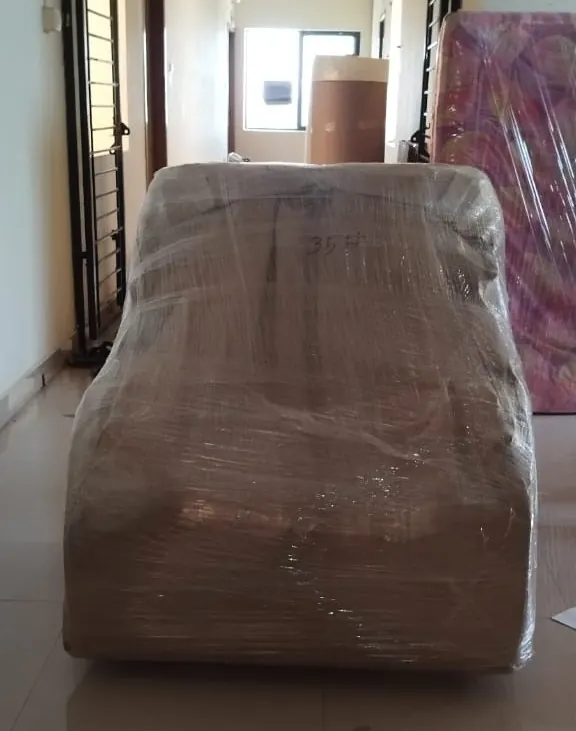 Sofa wrapped in brown packing sheet ready for a local move in Trichy